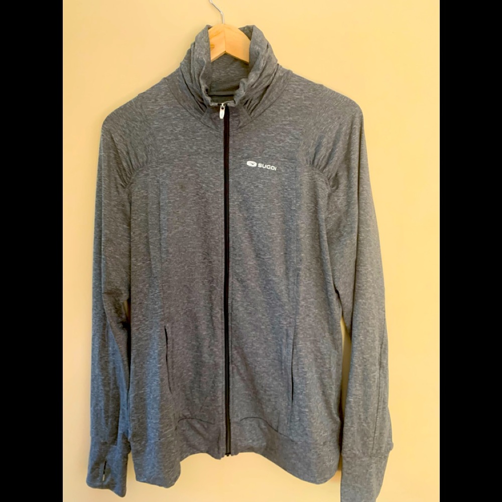 SUGOI jacket. Stand up collar. Zipper front. Ruching detail w/ thumb holes.